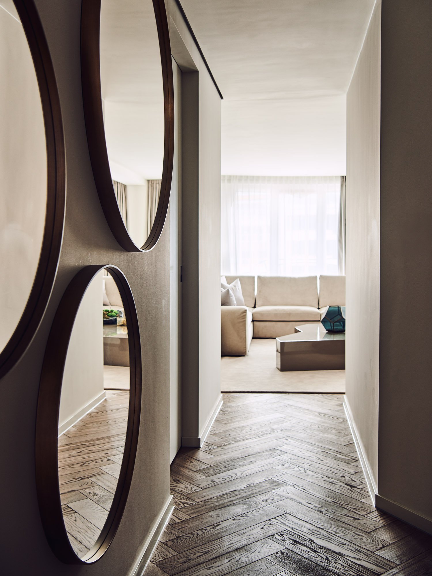interior design beige brown large round mirrors in hallway